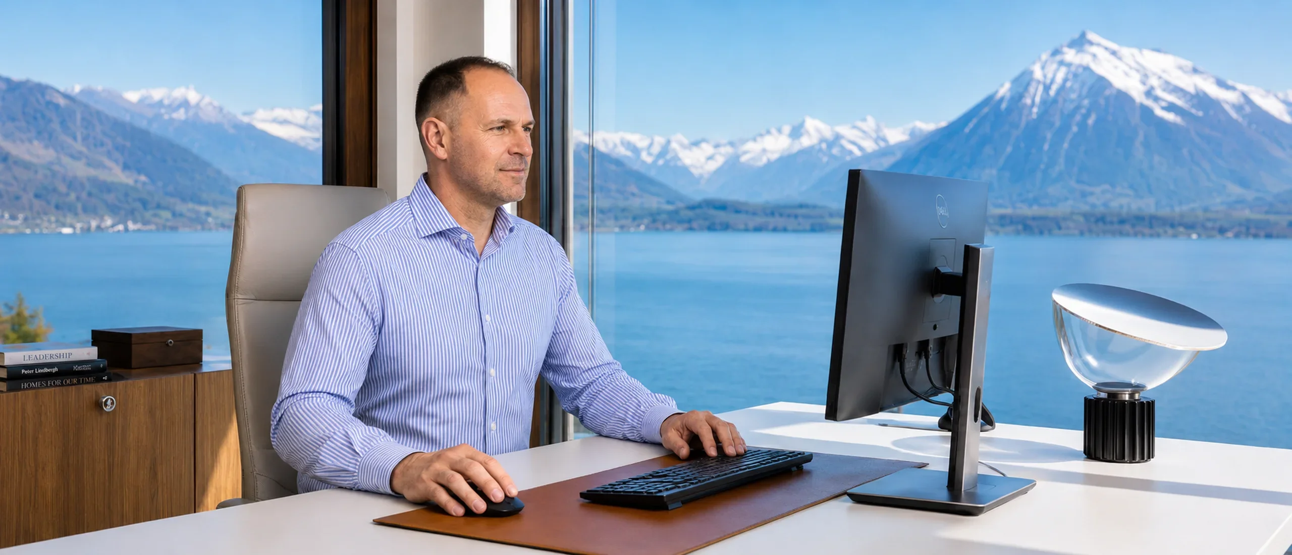 Ivan Schmid at his desk overlooking Lake Thun